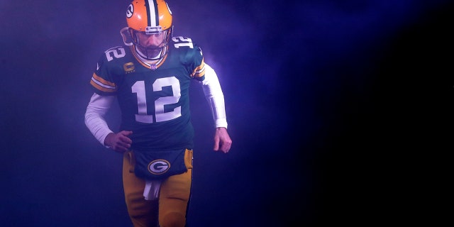 Packers quarterback Aaron Rodgers runs onto the field for the Detroit Lions game at Lambeau Field in Green Bay, Wisconsin on January 8, 2023.