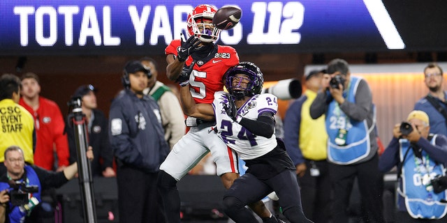 Adonai Mitchell #5 of the Georgia Bulldogs catches a touchdown pass late in the second quarter against Josh Newton #24 of the TCU Horned Frogs in the College Football National Championship game at SoFi Stadium on January 9, 2023, in Inglewood, California.
