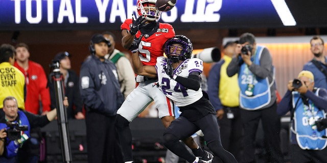 Adonai Mitchell #5 of the Georgia Bulldogs catches a touchdown pass late in the second quarter against Josh Newton #24 of the TCU Horned Frogs in the College Football National Championship game at SoFi Stadium on January 9, 2023, in Inglewood, California.