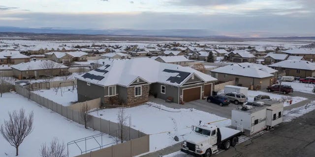 A home where eight people were found dead in Enoch, Utah, is pictured on Thursday. The southern Utah community was struggling for answers after police found eight people from one family, including five children, shot to death in the small town. 