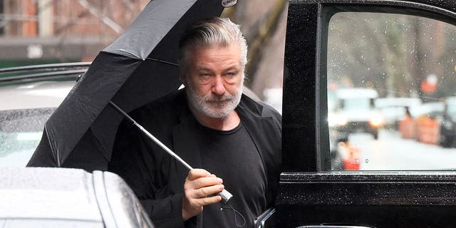 Alec Baldwin arriving home on Monday, after he was charged with two counts of involuntary manslaughter.