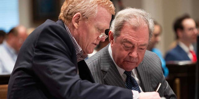 Alex Murdaugh and defense attorney Dick Harpootlian review evidence during his trial for murder at the Colleton County Courthouse on Tuesday, January 31, 2023. 