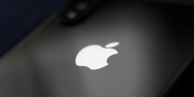 The Apple logo is seen on a mobile phone in this illustration photo taken on December 1, 2020 in Poland. 
