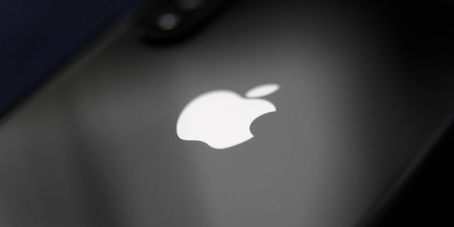 Apple logo is seen on a phone in this illustration photo taken in Poland on Dec. 1, 2020.