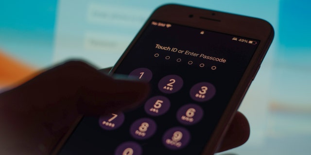 A mobile phone passcode security screen is seen in this photo illustration