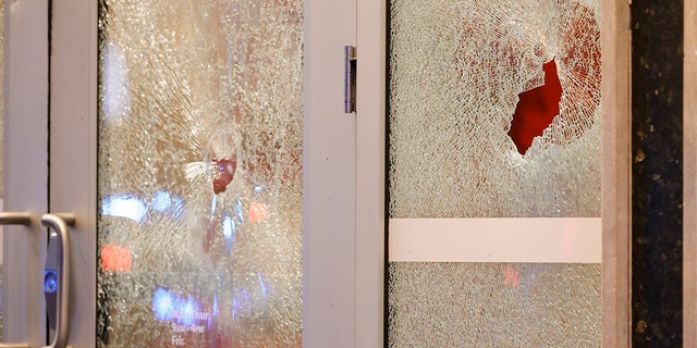 Broken windows at a Wells Fargo branch are seen following a protest, Saturday, Jan. 21, 2023, in Atlanta, in the wake of the death of an environmental activist killed after authorities said the 26-year-old shot a state trooper. 