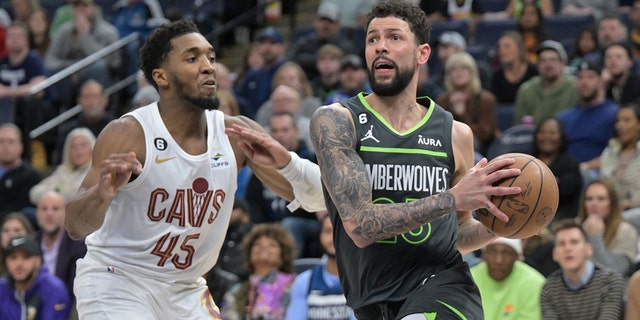 Minnesota Timberwolves guard Austin Rivers goes to the basket as Cleveland Cavaliers guard Donovan Mitchell defends at Target Center in Minneapolis on Jan. 14, 2023.