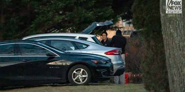 Police and investigators chatting after putting items into car, taken from Walshe home at 516 Chief Justice Cushing Highway, Cohasset, MA, after Brian Walshe and children departed.