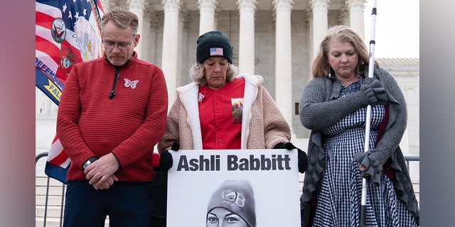 Micki Witthoeft, center, mother of Ashli Babbitt, the woman fatally shot by police inside the U.S. Capitol during the Jan. 6, 2021, riot, joins protesters outside of the Supreme Court on the second anniversary of the Jan. 6, assault on the U.S. Capitol, in Washington, Friday, Jan. 6, 2023.