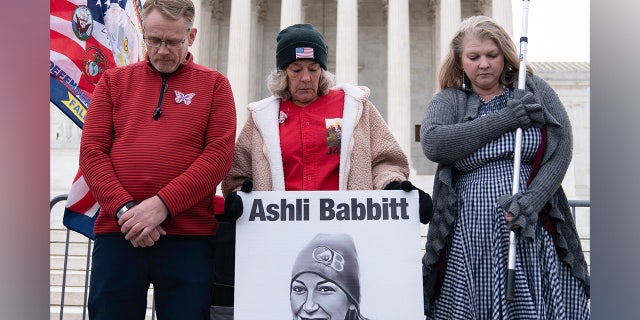 Micki Witthoeft, center, mother of Ashli Babbitt, the woman fatally shot by police inside the U.S. Capitol during the Jan. 6, 2021, riot, joins protesters outside of the Supreme Court on the second anniversary of the Jan. 6, assault on the U.S. Capitol, in Washington, Friday, Jan. 6, 2023.