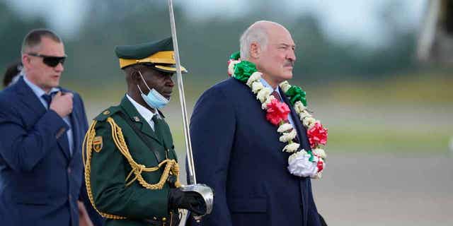 Belarus President Alexander Lukashenko, right, arrives at Robert Mugabe International airport, in Harare, Zimbabwe, on Jan. 30, 2023.