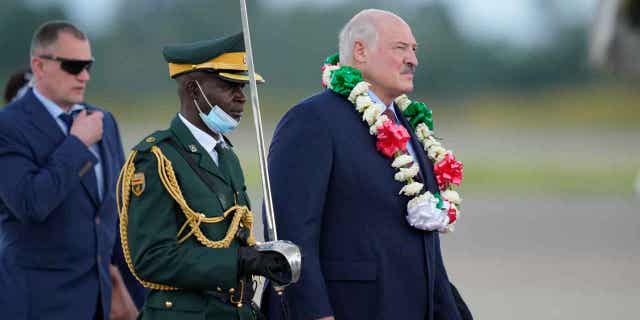 Belarus President Alexander Lukashenko, right, arrives at Robert Mugabe International airport, in Harare, Zimbabwe, on Jan. 30, 2023.