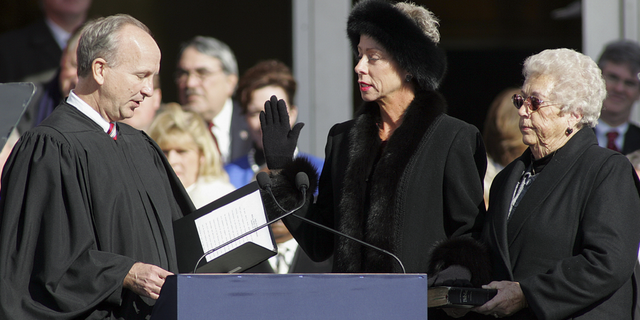 North Carolina State Auditor Beth Wood, center, is sworn into office by Supreme Court Justice Paul Newby as her mother Betty Wood looks on during North Carolina inaugural ceremonies on Jan. 10, 2009, at the State Library building in Raleigh.