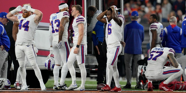 Buffalo Bills players react as teammate Damar Hamlin is examined during the first half of an NFL football game against the Cincinnati Bengals, Monday, Jan. 2, 2023, in Cincinnati. 