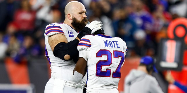Mitch Morse, #60 of the Buffalo Bills, consoles Tre'Davious White, #27, after Damar Hamlin, #3, sustained an injury during the first quarter of an NFL football game against the Cincinnati Bengals at Paycor Stadium on Jan. 2, 2023 in Cincinnati.
