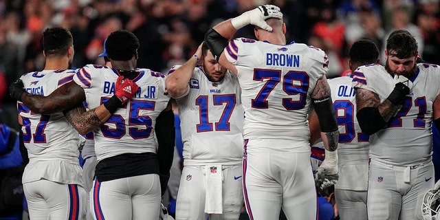 The Buffalo Bills gather while CPR is administered to their teammate, safety Damar Hamlin, Jan. 2, 2023, in Cincinnati.