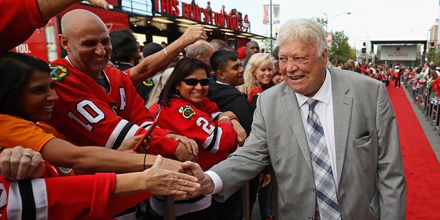 Former player and member of the Hockey Hall of Fame Bobby Hull, of the Chicago Blackhawks, greets fans during a 