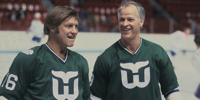 Gordie Howe, #9, and Bobby Hull, #16 of the Hartford Whalers, look on against the Montreal Canadiens in the 1980's at the Montreal Forum in Montreal.