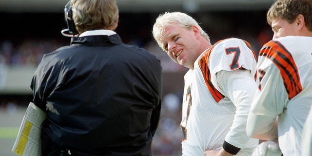 Quarterback Boomer Esiason #7 of the Cincinnati Bengals looks at head coach Sam Wyche during a game against the Pittsburgh Steelers at Three Rivers Stadium on October 25, 1987 in Pittsburgh, Pennsylvania.