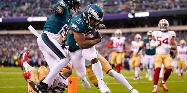 Philadelphia Eagles running back Boston Scott, center, runs for a touchdown during the first half of the NFC Championship NFL football game between the Philadelphia Eagles and the San Francisco 49ers on Sunday, Jan. 29, 2023, in Philadelphia.