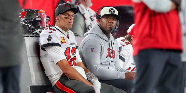 Tampa Bay Buccaneers quarterback Tom Brady, #12, sits with offensive coordinator Byron Leftwich during the NFC Wild Card Playoff game between the Dallas Cowboys and the Tampa Bay Buccaneers on Jan. 16, 2023 at Raymond James Stadium in Tampa, Florida.