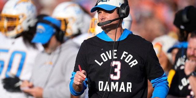 Los Angeles Chargers head coach Brandon Staley wears a T-shirt to show support for Buffalo Bills safety Damar Hamlin during the first half of an NFL football game against the Denver Broncos in Denver, Sunday, Jan. 8, 2023. 