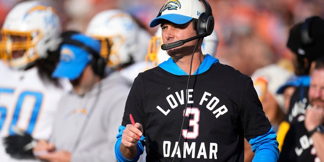 Los Angeles Chargers head coach Brandon Staley wears a jersey to show support for Buffalo Bills safety Damar Hamlin during the first half of an NFL football game against the Denver Broncos in Denver , on Sunday, January 8, 2023. 