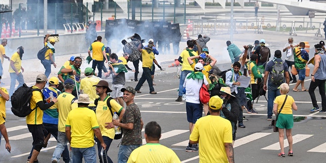 Supporters of Brazilian former President Jair Bolsonaro clash with the police during a demonstration outside the Planalto Palace in Brasilia on January 8, 2023.