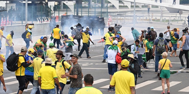 Supporters of Brazilian former President Jair Bolsonaro clash with the police during a demonstration outside the Planalto Palace in Brasilia on January 8, 2023.