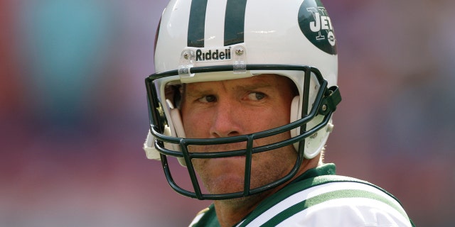 New York Jets quarterback Brett Favre, #4, warms up before the game against the New England Patriots at Giants Stadium.