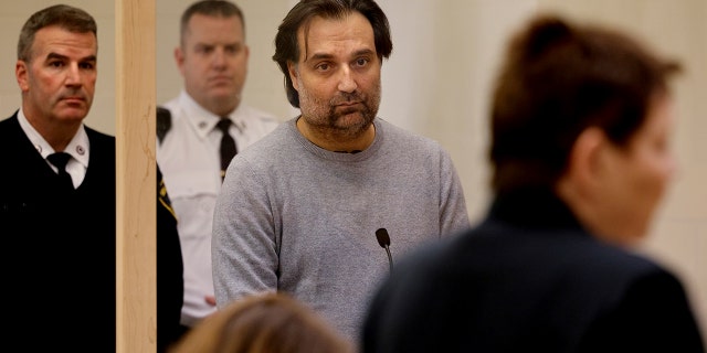 Brian Walshe, center, listens during his arraignment Wednesday, Jan. 18, 2023, at Quincy District Court, in Quincy, Mass., on a charge of murdering his wife Ana Walshe. Not guilty pleas were entered on behalf of Walshe, 47. Ana Walshe was reported missing Jan. 4, 2023 by her employer in Washington, where the couple has a home.