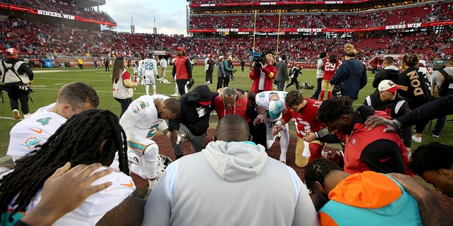 San Francisco 49ers quarterback Brock Purdy prays with other players after their 33-17 win over the Miami Dolphins at Levi's Stadium in Santa Clara, California, on Dec. 4, 2022.