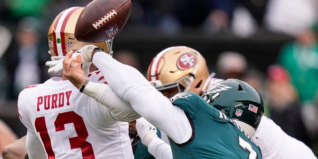 Philadelphia Eagles linebacker Haason Reddick, right, forces a fumble by San Francisco 49ers quarterback Brock Purdy during the first half of the NFC championship game Jan. 29, 2023, in Philadelphia.