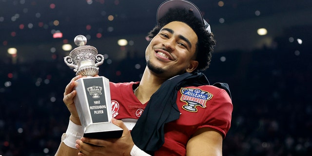 Alabama quarterback Bryce Young holds the man of the match trophy as he celebrates after the Sugar Bowl NCAA college football game where Alabama defeated Kansas State 45-20, Saturday, Dec. 31, 2022, in New Orleans.