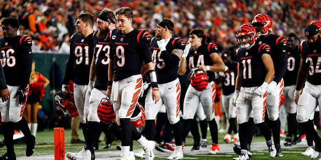 Joe Burrow #9 of the Cincinnati Bengals and his teammates walk to the locker room after the game against the Buffalo Bills was called after Damar Hamlin of the Bills collapsed on the field on January 2, 2023, in Cincinnati .