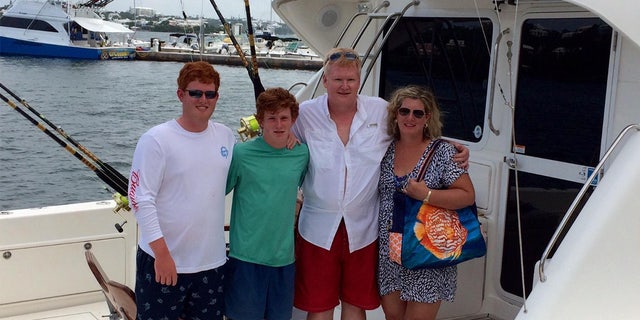 From left to right, Buster, Paul, Alex and Maggie Murdaugh pose together on a fishing boat.