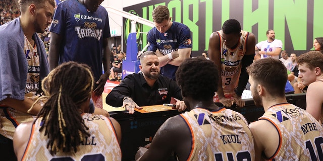 Adam Forde, head coach of the Cairns Taipans, speaks to players during the game against South East Melbourne Phoenix at the State Basketball Center on January 25, 2023 in Melbourne, Australia.