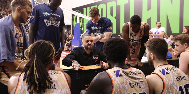 Adam Forde, head coach of the Cairns Taipans, speaks to players during the game against South East Melbourne Phoenix at the State Basketball Center on January 25, 2023 in Melbourne, Australia.