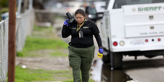 GOSHEN, CA - JANUARY 16: Tulare County Sheriff crime unit investigates the scene where six people, including a 6-month-old baby, her teenage mother and an elderly woman, were killed in a Central Valley farming community in what the local sheriff said was likely a targeted attack by a drug cartel on Monday, Jan. 16, 2023 in Goshen, CA. The massacre occurred around 3:30 a.m. in and around a residence in the Tulare County town of Goshen near Visalia. (Gary Coronado / Los Angeles Times via Getty Images)