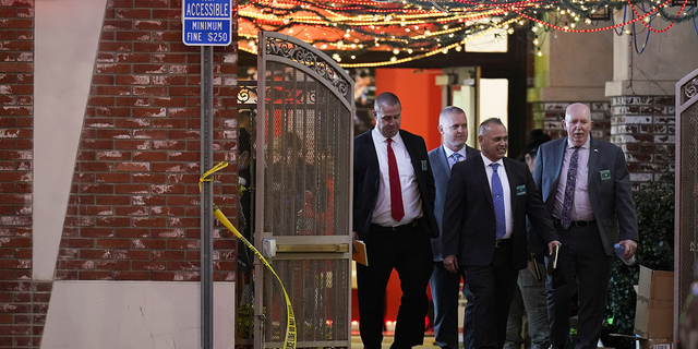 Investigators leave the Star Ballroom Dance Studio following Saturday's fatal mass shooting in Monterey Park, California.