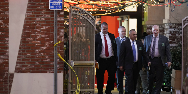 Investigators leave the Star Ballroom Dance Studio following Saturday's fatal mass shooting in Monterey Park, California.