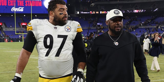 Cameron Heyward and head coach Mike Tomlin of the Pittsburgh Steelers celebrate after defeating the Ravens 16-13 on January 1, 2023 in Baltimore.