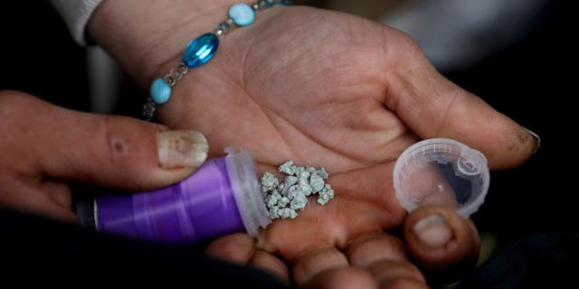 A man shows an eight ball, or 3.5 grams, of fentanyl along East Hastings Street in the Downtown Eastside neighborhood on Tuesday, May 3, 2022 in Vancouver, British Columbia.