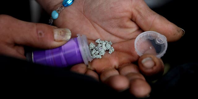 A man shows an eight ball, or 3.5 grams, of fentanyl along East Hastings Street in the Downtown Eastside neighborhood on Tuesday, May 3, 2022 in Vancouver, British Columbia.
