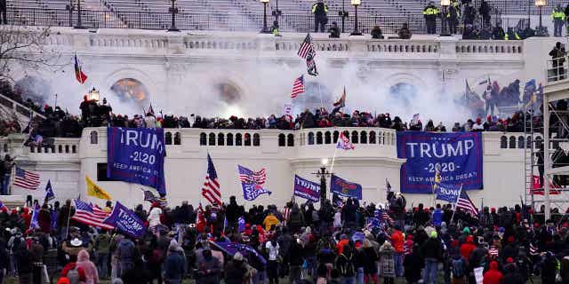 Insurrectionists are pictured storming the Capitol on Jan. 6, 2021, in Washington, D.C. A man who put his feet up on Pelosi's desk was found guilty of charges that stemmed from the insurrection.