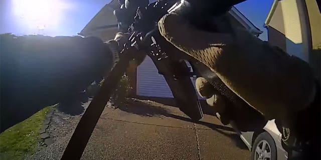 Nashville SWAT team approaches home of Mark Capps with their guns drawn.