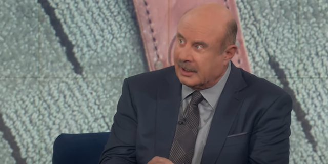 Dr. Phil holding a knife in a sheath and discussing the specifics of the weapon used in the Idaho murders.