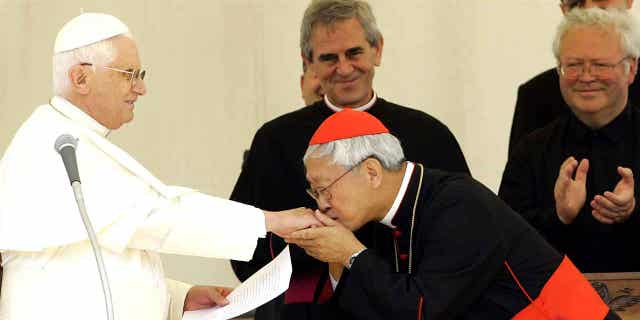 Chinese Cardinal Joseph Zen, right, Bishop of Hong Kong, kisses the hand of Pope Benedict XVI after the traditional Angelus prayer in Lorenzago di Cadore, Italy, on July 22, 2007. Zen will attend the funeral of Pope Bendecict XVI on Thursday.