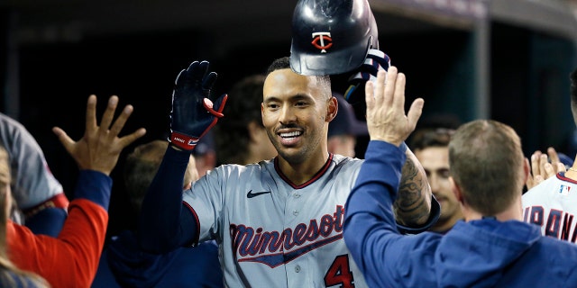 Carlos Correa (4) of the Minnesota Twins celebrates with teammates in the dugout after hitting a two-run home run against the Detroit Tigers during the seventh inning at Comerica Park Sept. 30, 2022, in Detroit.