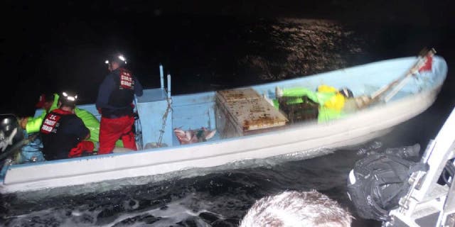 Two crew members from the Coast Guard Cutter Benjamin Dailey (manning Coast Guard Cutter Jacob Poroo) direct a Mexican fisherman aboard a lancha approximately 15 miles offshore the southern Texas coast Saturday, Jan. 7, 2022. The guardsmen search the boat.